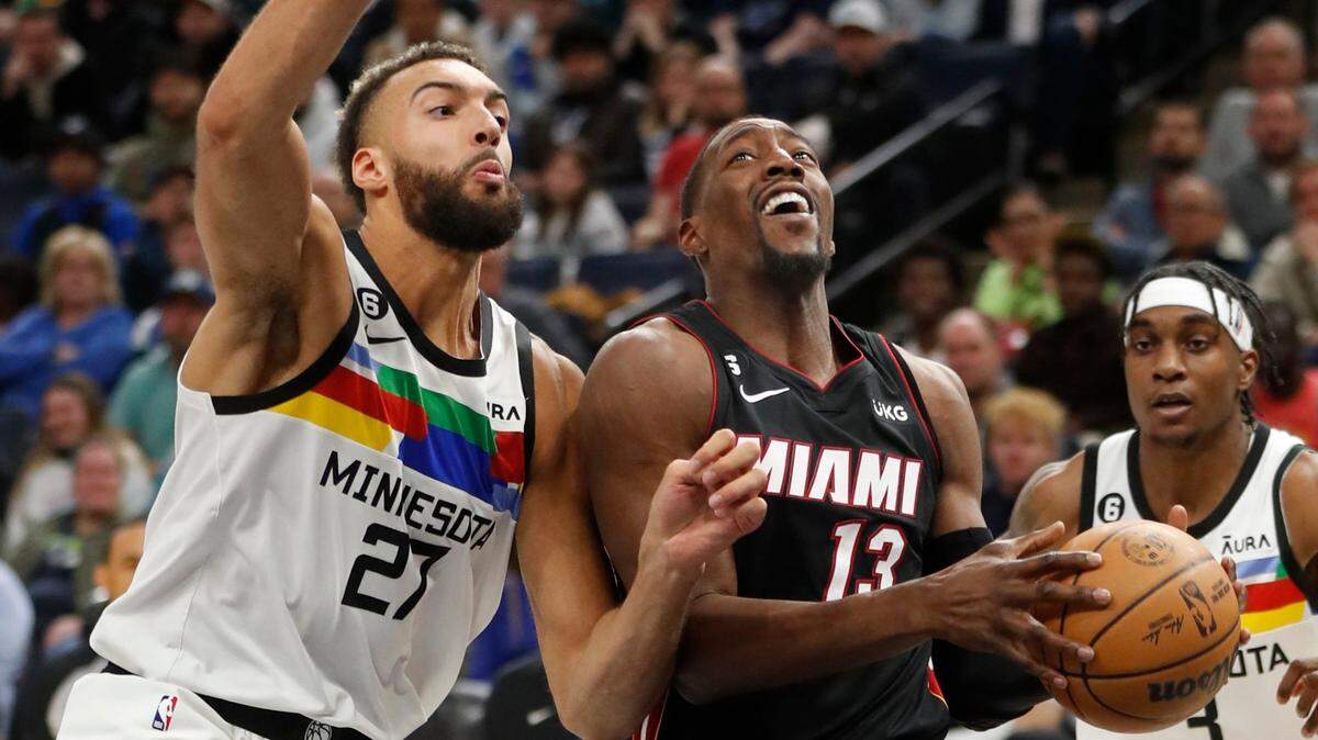 Miami Heat center Bam Adebayo (13) goes to the basket as Minnesota Timberwolves center Rudy Gobert (27) defends him in the third quarter of an NBA basketball game, Monday, Nov. 21, 2022, in Minneapolis. The Timberwolves won 105-101.