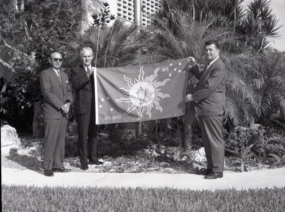 Key West Mayor Kermit Lewin, right, shows off Key West’s flag in the 1960s.