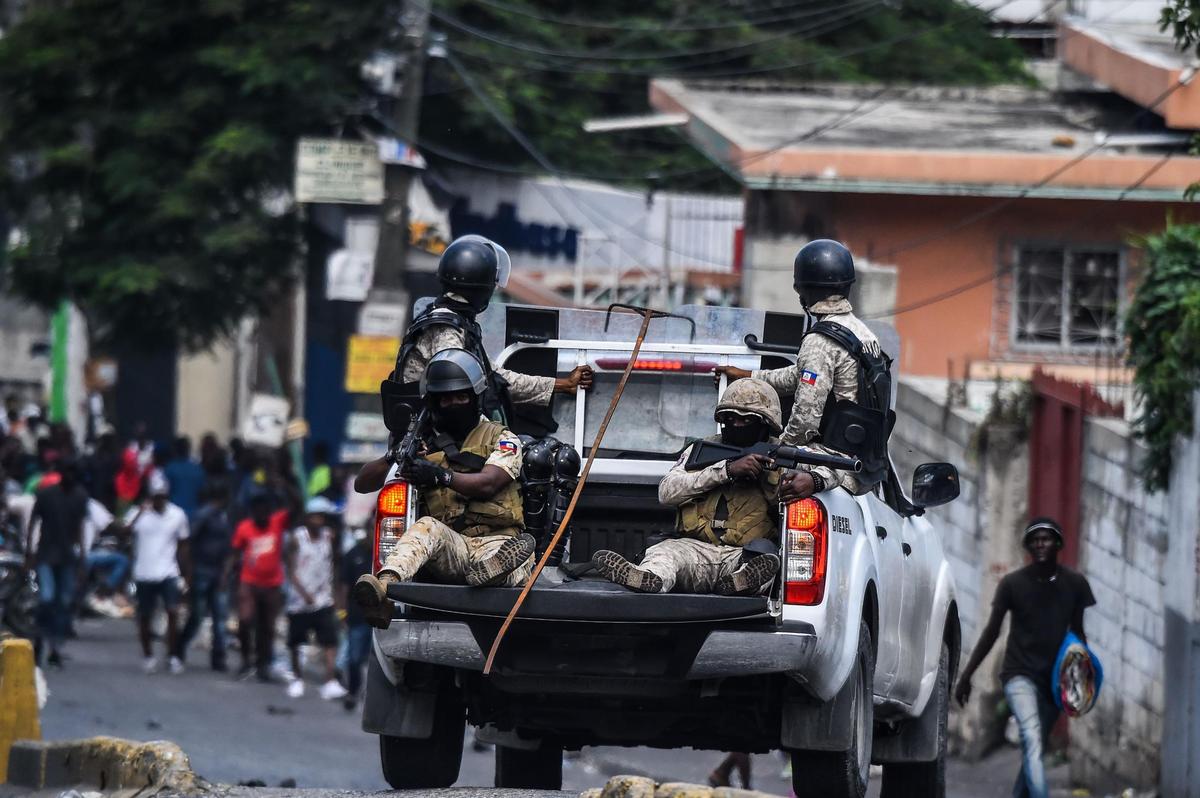 Haitian police patrol the streets of Port-au-Prince as protesters demand the resignation of President Jovenel Moïse. A police station in the Haitian capital was targeted during Friday’s demonstrations.