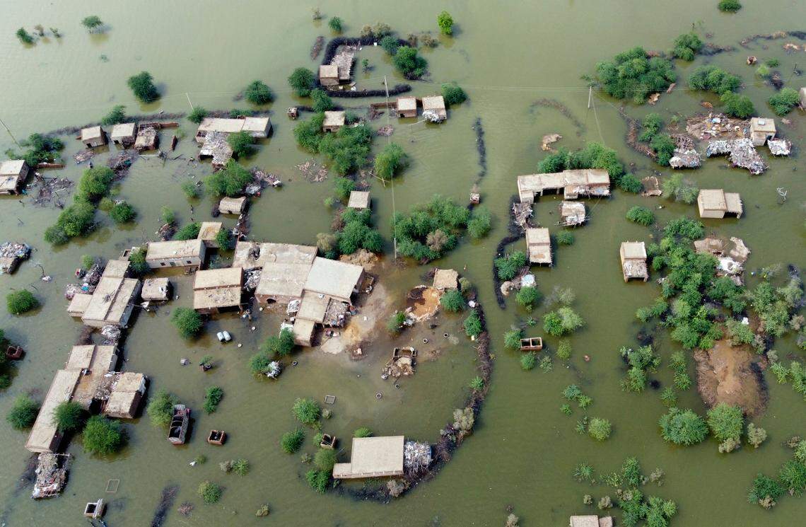 Homes are surrounded by floodwaters in Sohbat Pur city, a district of Pakistan’s southwestern Baluchistan province, Tuesday, Aug. 30, 2022.