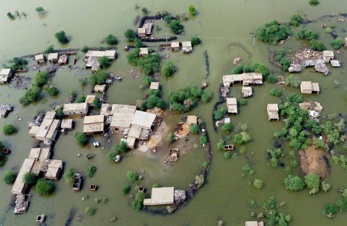 Homes are surrounded by floodwaters in Sohbat Pur city, a district of Pakistan’s southwestern Baluchistan province, Tuesday, Aug. 30, 2022.