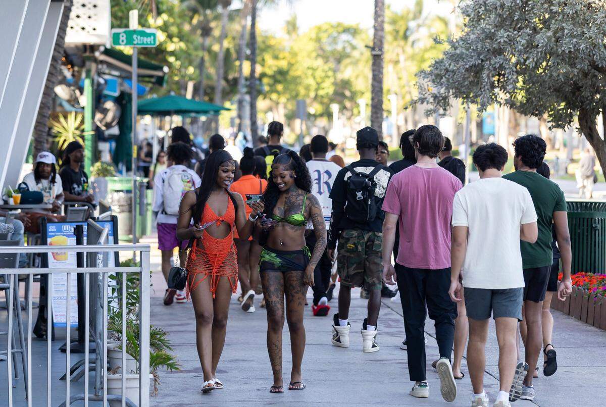 People make their way down Ocean Drive.