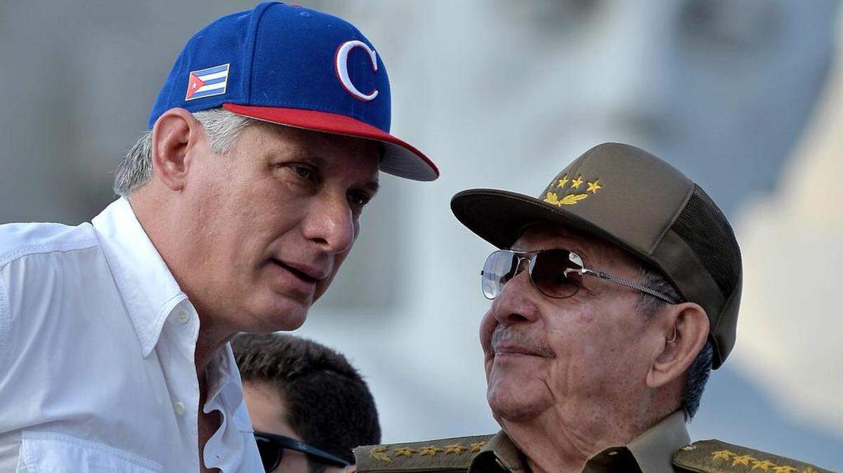 (FILES) In this file photo taken on May 01, 2018 Cuban President Miguel Diaz-Canel (L) listens to former president Raul Castro during the May Day rally at Revolution Square in Havana. - Opening to market and private investment without giving up socialism: this is one of the main changes in the new Cuban Constitution, which also limits the presidential mandate and ushers in homosexual marriage. The text, which will replace the current Magna Carta, which dates from 1976, will be submitted to a referendum on February 24. (Photo by Yamil LAGE / AFP)YAMIL LAGE/AFP/Getty Images