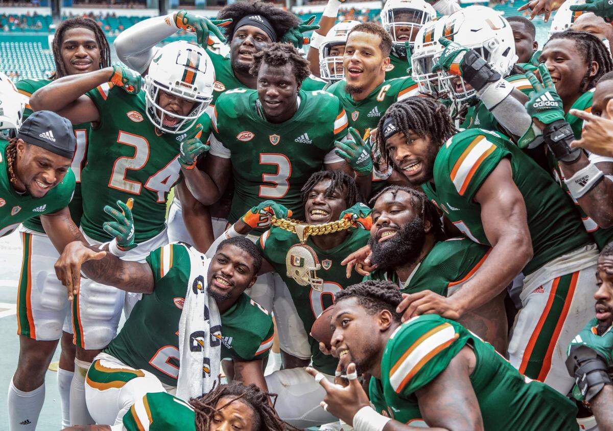 Miami Hurricanes safety James Williams (0) celebrates with teammates and the turnover chain after intercepting a Central Connecticut State Blue Devils pass in the third quarter at Hard Rock Stadium in Miami Gardens on Saturday, September 25, 2021.