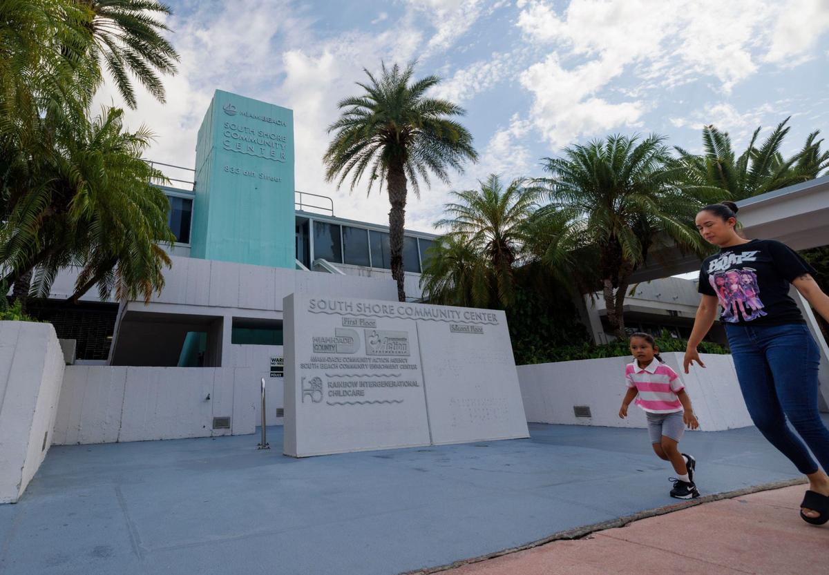 A woman and her daughter walk past the South Shore Community Center, one of the proposed locations for a new Miami Beach Fire Station No. 1, on Wednesday, Aug. 7, 2024, in Miami Beach, Fla.