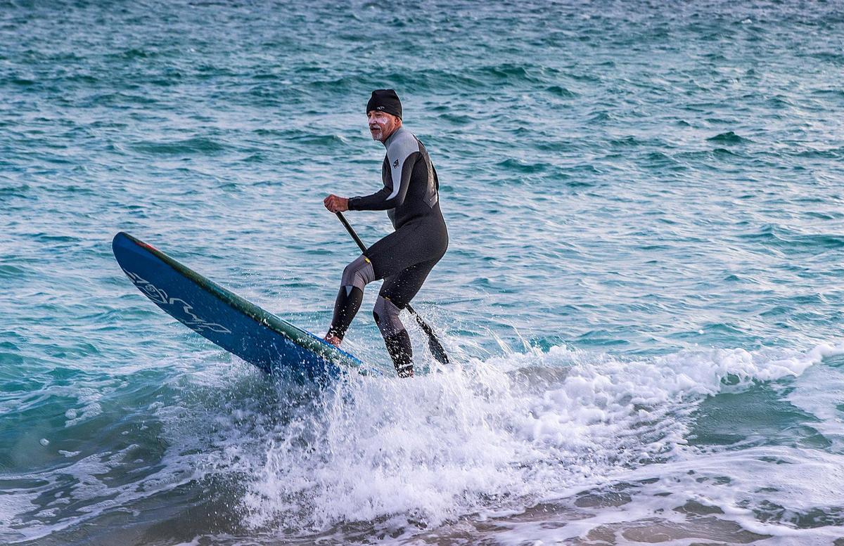 Surfer Johnny Z took his paddle board to the water in South Pointe, Miami Beach, as temperatures only climed to 48 degrees Saturday morning, Dec. 24, 2022.