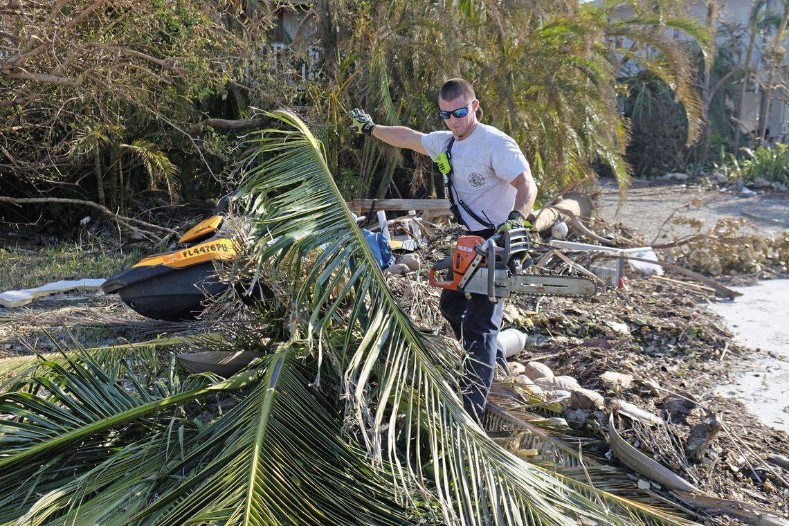Michael Bernard with Monroe County Fire Rescue trims a tree from a Cudjoe Key roadway on Sept. 13, 2017.  Hurricane Irma left the island community devastated.