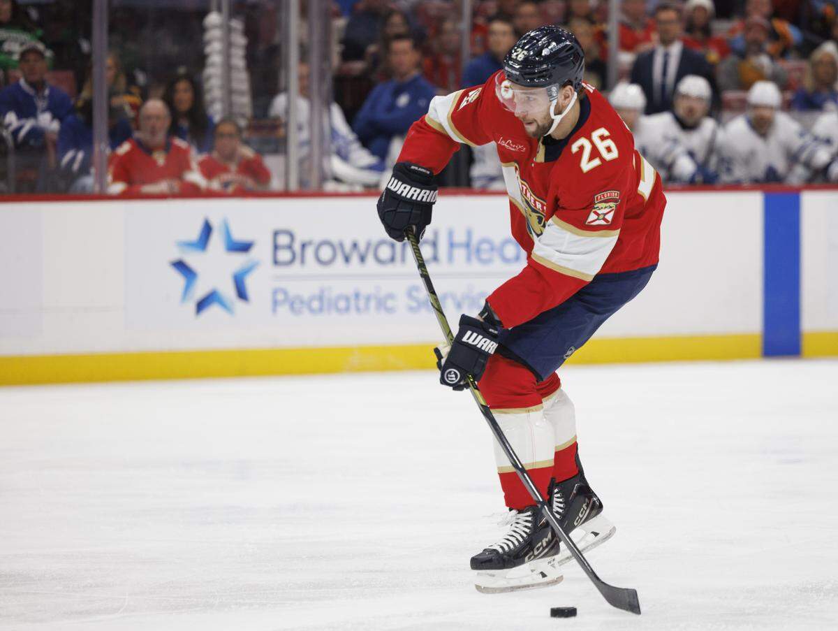 Florida Panthers defenseman Uvis Balinskis (26) passes the puck during the first period of a game against the Toronto Maple Leafs on Tuesday, Dec. 2, 2025, at Amerant Bank Arena in Sunrise, Fla.