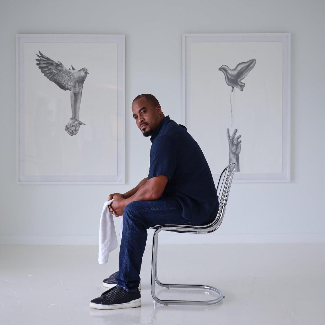 Jumaane N’Namdi is director of the Little Haiti gallery N’Namdi Contemporary Miami. While he thinks Art Basel’s cancelation is unfortunate, he said he’s looking forward to getting a break. Jumaane is photographed among Detroit artist Rashaun Rucker’s exhibition “Contemplation of Flight” show on Wednesday, November 25, 2020.h