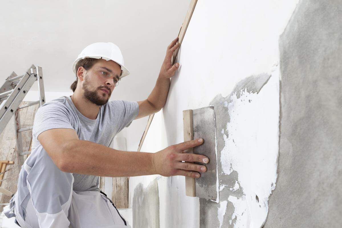 construction worker plastering wall