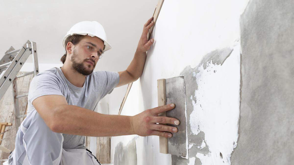 construction worker plastering wall