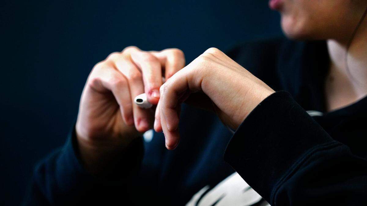 File Art: A 17-year-old junior at Clermont Northeastern High School in Batavia, Ohio, holds a vape pen.