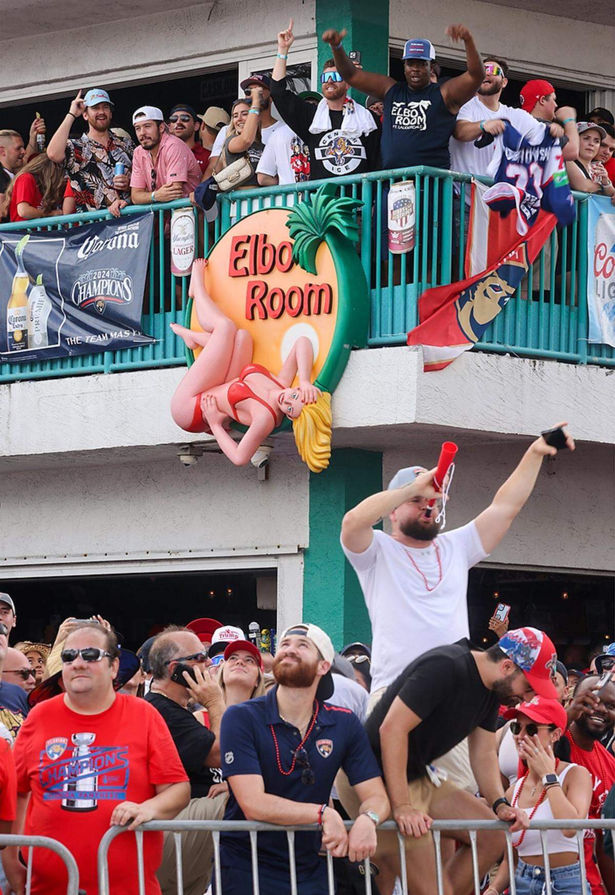 Panthers fans pack the Elbo Room, a local favorite spot of some Panther players, as they cheer on the raising of the American flag on the parade route for the celebration of the Florida Panthers’ Stanley Cup win in Fort Lauderdale on Sunday, June 30, 2024.
