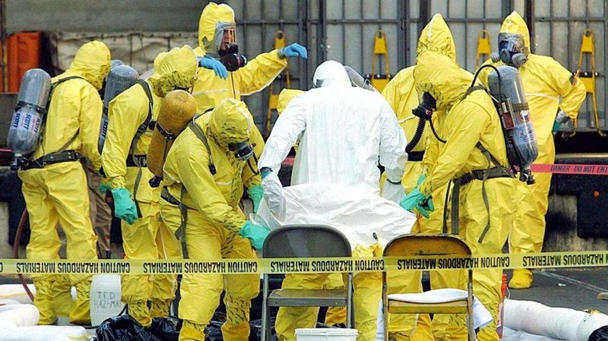 In 2001, members of a hazardous-materials response team remove a hazmat suit from an investigator at a West Trenton, New Jersey, post office. Two letters containing anthrax were traced to this facility.