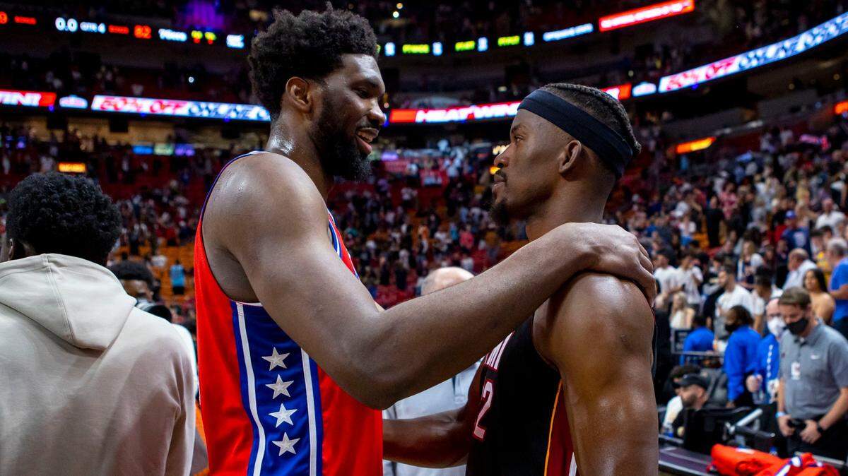 Miami Heat forward Jimmy Butler (22) speaks with Philadelphia 76ers center Joel Embiid (21) after the fourth quarter of an NBA game at FTX Arena in Downtown Miami, Florida, on Saturday, March 5, 2022. The Sixers fell to the Heat 99-82.