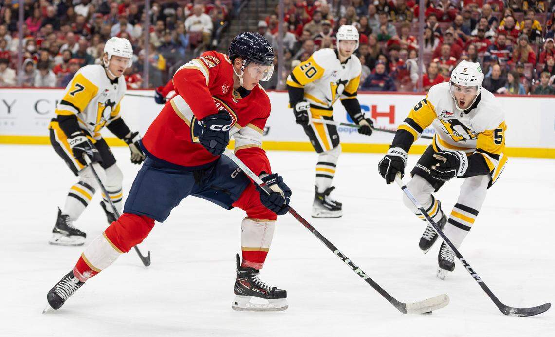 Florida Panthers center Anton Lundell (15) skates with the puck as Pittsburgh Penguins defenseman Ryan Shea (5) goes to defend in the first period of their NHL game at the Amerant Bank Arena on Friday, Dec. 8, 2023, in Sunrise, Fla.