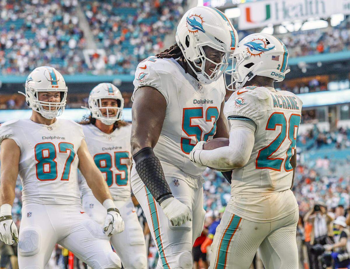 Miami Dolphins running back De'Von Achane (28) and offensive tackle Patrick Paul (52) celebrate in the endzone after Achane scores in the second half of the NFL football game against the Buffalo Bills at Hard Rock Stadium in Miami Gardens, Florida on Sunday, November 9, 2025.