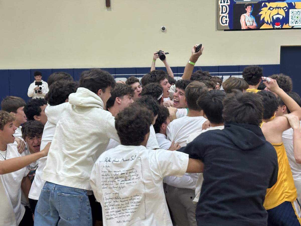 Belen Jesuit’s fans rushed onto the court after the Wolverines’ volleyball team beat Varela to secure the Region 4-2A championship on Friday night at Belen Jesuit.