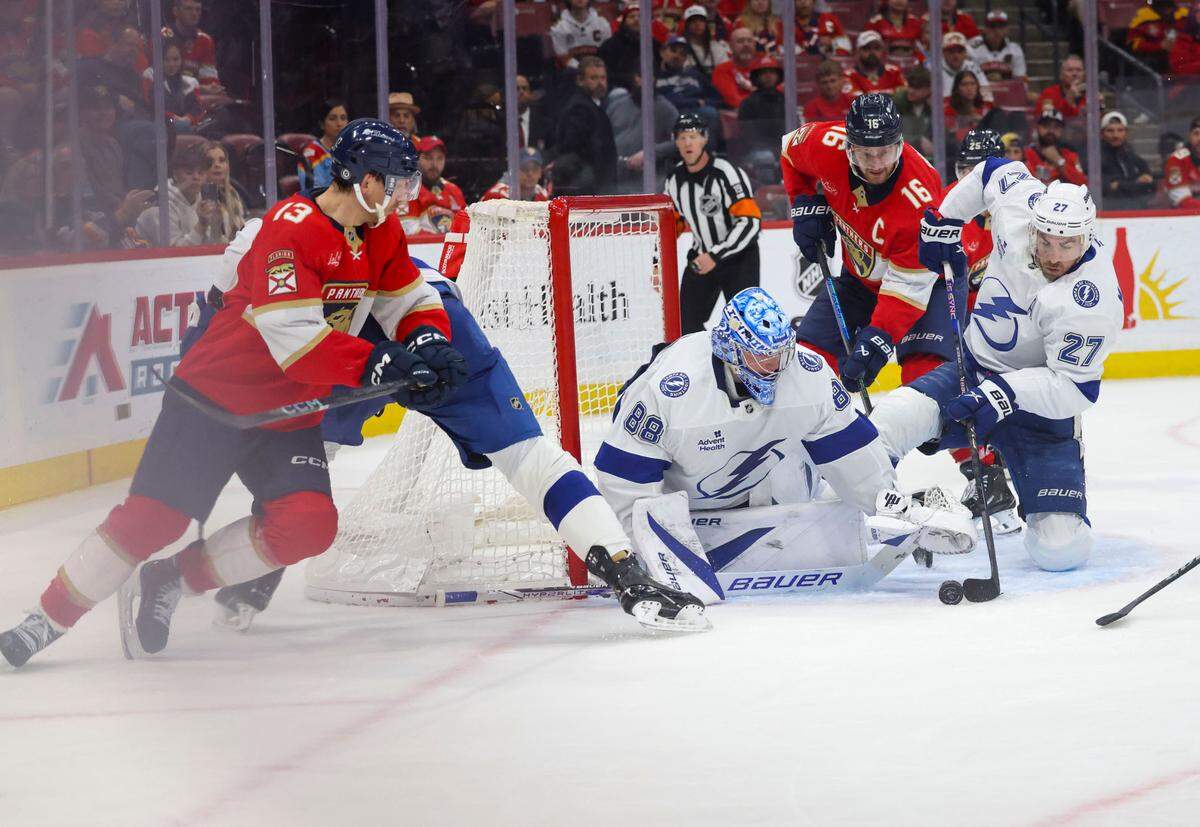 Tampa Bay Lightning defenseman Ryan McDonagh (27) tries to get the puck away from the goal during the third period of a game against the Florida Panthers on Monday, March 3, 2025, at Amerant Bank Arena in Sunrise, Fla. The Florida Panthers won 2-1.