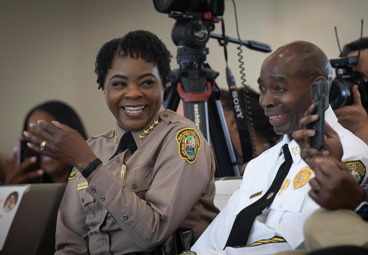 Miami-Dade Police Director Stephanie V. Daniels, left, laughs after a speaker says she must be proud of her husband, Capt. Desi Daniels, of the Miami-Dade Corrections and Rehabilitation Department, during her investiture ceremony at PortMiami on Wednesday, Jan. 10, 2024.