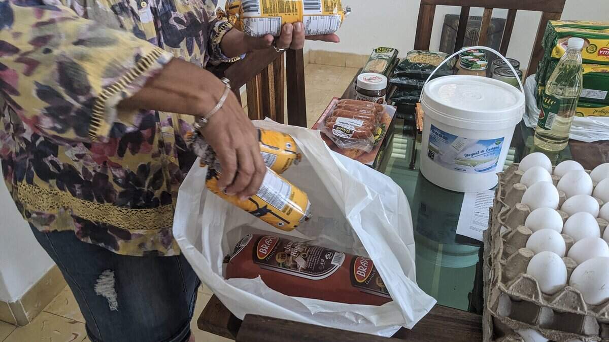 Maria Paez, 59, organizes the food that her children sent her from Miami through a food remittance distributor in Havana on May 16, 2024. Due to the crisis, Cuban emigrants choose to send food, sacrificing the vital cash remittances that the island requires. Currently, it is possible to send food and other essential products to Cuba from several dozen online platforms, based mainly in the United States, where more than two million Cubans live, but also in Mexico, Canada, and Spain. (Photo by STRINGER / AFP) (Photo by STRINGER/AFP via Getty Images)