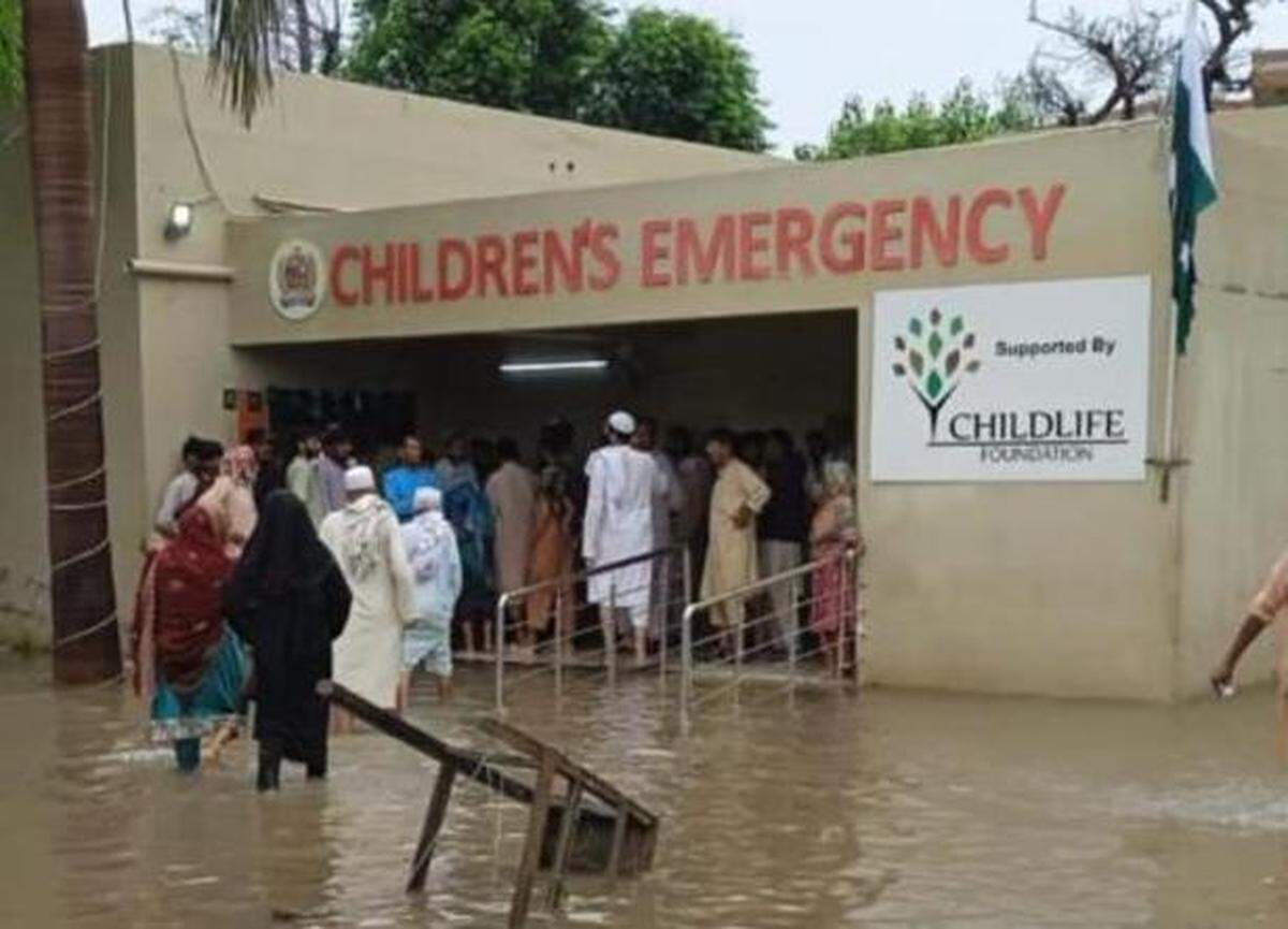 Dozens of Pakistanis seeking medical attention line up outside an emergency room funded by Childlife Foundation. Childlife staff have seen more than 100,000 patients this year, a number that continues to rise due to recent flooding.