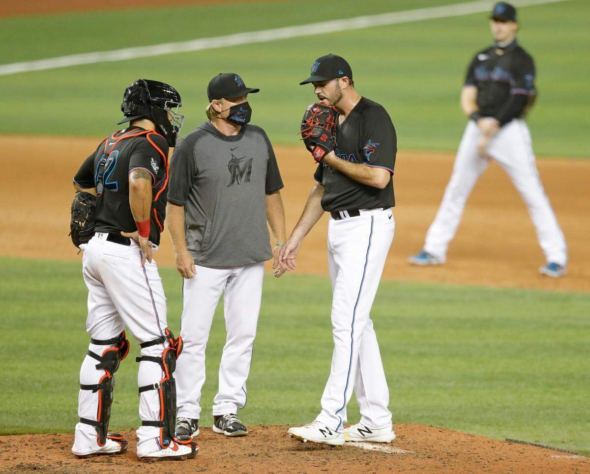 Marlins catcher Jorge Alfaro, pitching coach Mel Stottlemyre Jr. and pitcher James Hoyt talk on the mound as the Miami Marlins host the Tampa Bay Rays at Marlins Park in Miami on Saturday, August 29, 2020.