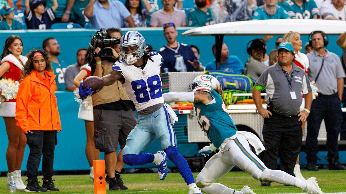Dallas Cowboys wide receiver CeeDee Lamb (88) scores a touchdown as Miami Dolphins linebacker Duke Riley (45) defends during first quarter of an NFL football game at Hard Rock Stadium on Sunday, Dec. 24, 2023 in Miami Gardens, Fl.