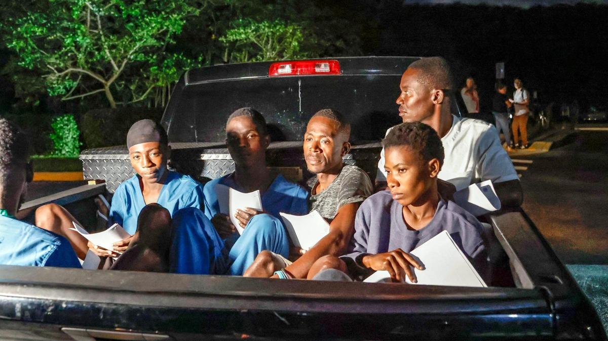 A group of people speaking Creole depart the U.S. Customs and Border Protection Dania Beach Border Patrol Station, as families await the arrival of Cuban migrants on Thursday, Jan. 5, 2023.