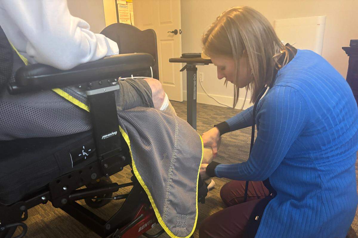 Stephanie Johnson examines her patient Ellen’s foot. Ellen had been diagnosed with vascular dementia, peripheral vascular disease, and Type 2 diabetes. Last fall, doctors made the difficult decision to operate on her foot.