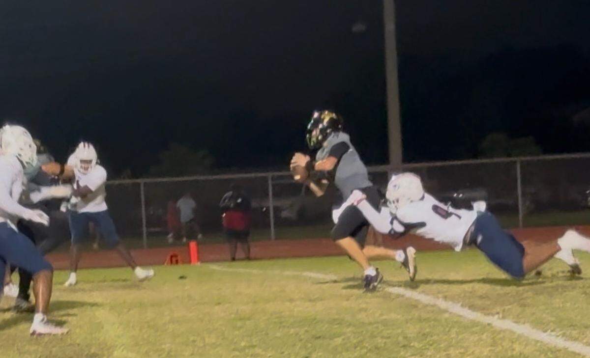 Chaminade defensive end Donta Simpson pulls down Western quarterback Sebastian Circo for a sack during Friday’s game at the Wildcats’ home stadium in Davie, Fla.