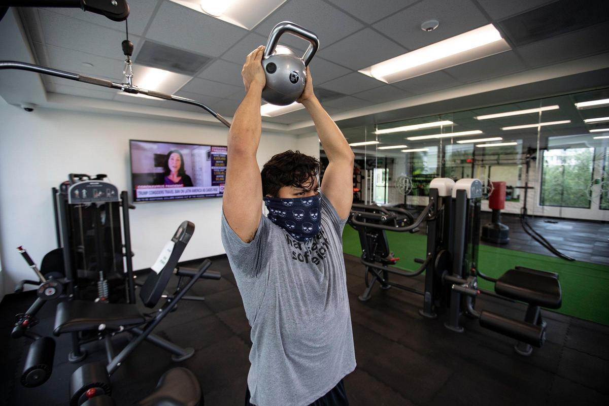 Fitness District client Tony Pardo, 29, returns to work out at the gym for the first time since the coronavirus outbreak on Wednesday, May 20, 2020, in Fort Lauderdale.