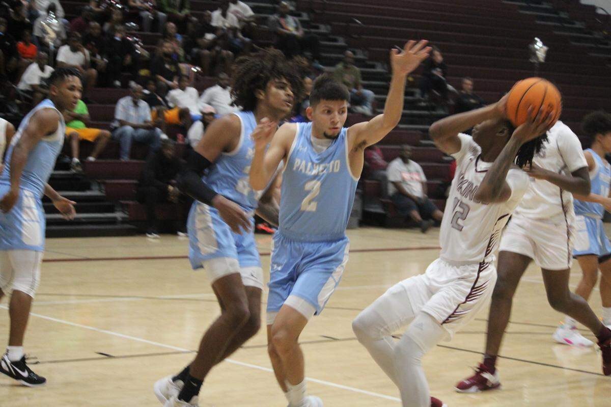 Palmetto’s Matthew Mairena goes up to try to block a shot by Norland’s Carl Parrish during Wednesday night’s GMAC boys basketball semifinal at Norland High.