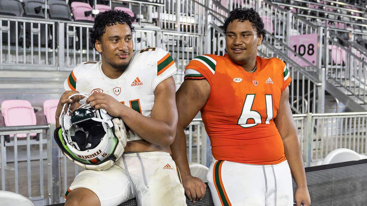 Miami Hurricanes linebacker Francisco Mauigoa (51) and his brother offensive lineman Francis Mauigoa (61) talk after they finished playing their spring game at DRV PNK Stadium on Friday, April 14, 2023, in Fort Lauderdale, Fla.