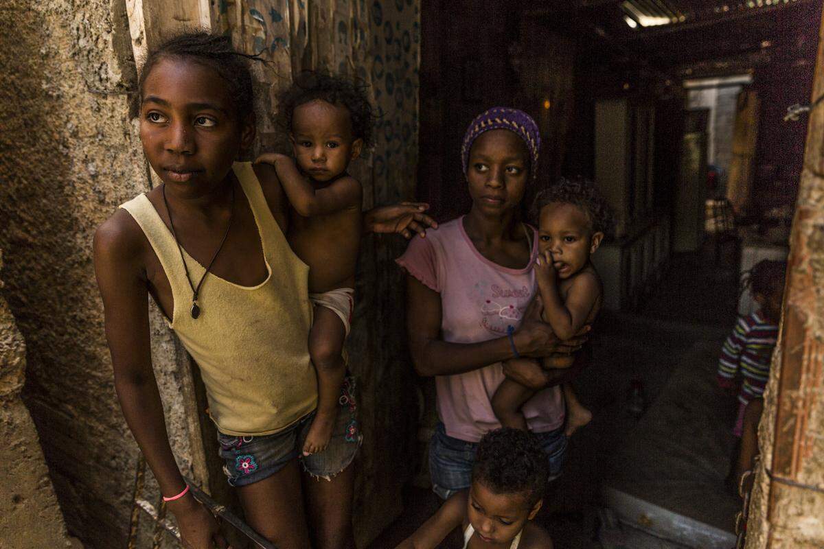 A family in Petare, outside Caracas, Venezuela, waits outside for the electricity to come back on, a problem they deal daily as part of continual blackouts.