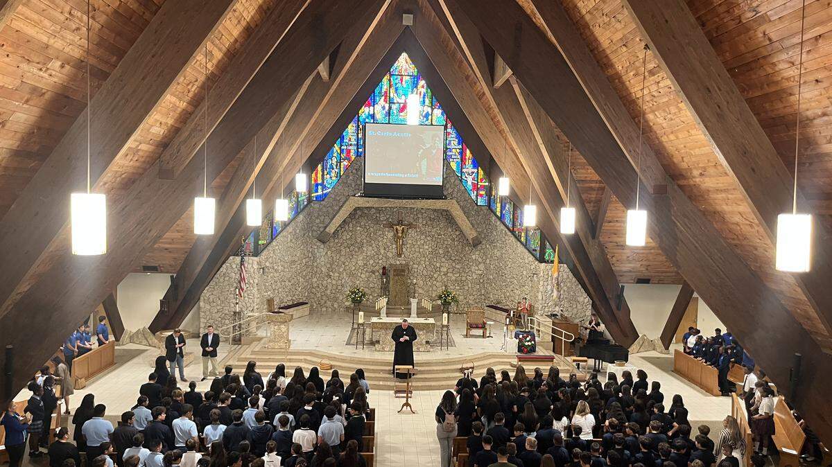 Father Ryan Saunders leads a mass for students and staff from across the Archdiocese of Miami to celebrate Saint Carlo Acutis, the first Millennial saint in the Catholic Church.