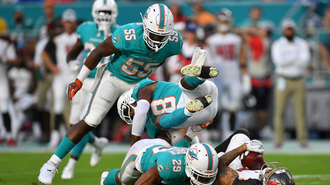 Linebacker Jerome Baker (55), cornerback Bobby McCain (28), and safety Minkah Fitzpatrick (29) make a tackle on Tampa Bay receiver Mike Evans (13) during Thursday’s preseason game. All took on expanded roles in Sunday’s practice, with Baker beginning practice at starting strongside linebacker.