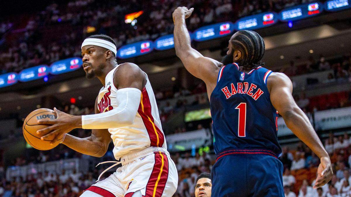 Miami Heat forward Jimmy Butler (22) hangs in the air as he pases the ball around Philadelphia 76ers guard James Harden (1) during the first quarter of Game 1 of a second round NBA Eastern Conference semifinal playoff series at FTX Arena in Miami, Florida, on Monday, May 2, 2022.