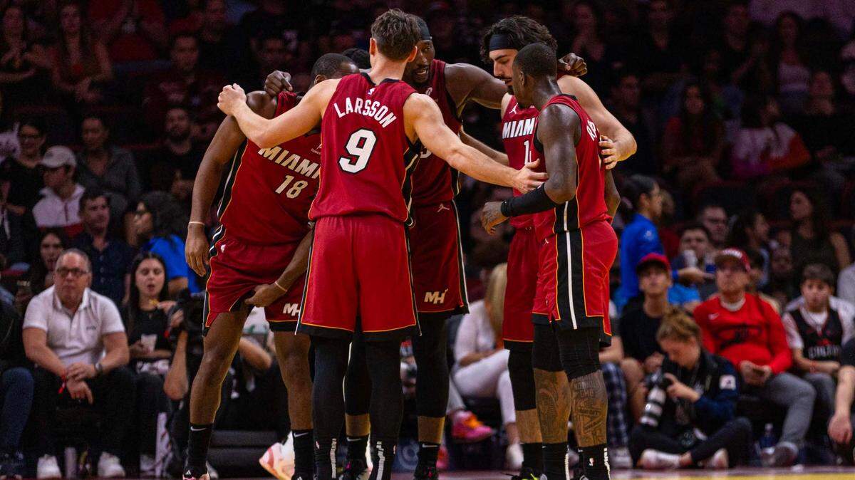 Miami Heat center Bam Adebayo (13) speaks to his teammates Alec Burks (18), Pelle Larsson (9), Jaime Jaquez Jr. (11) and Terry Rozier (2) while in a huddle during an NBA game against the Toronto Raptors at Kaseya Center on Nov. 29, 2024 in Miami.