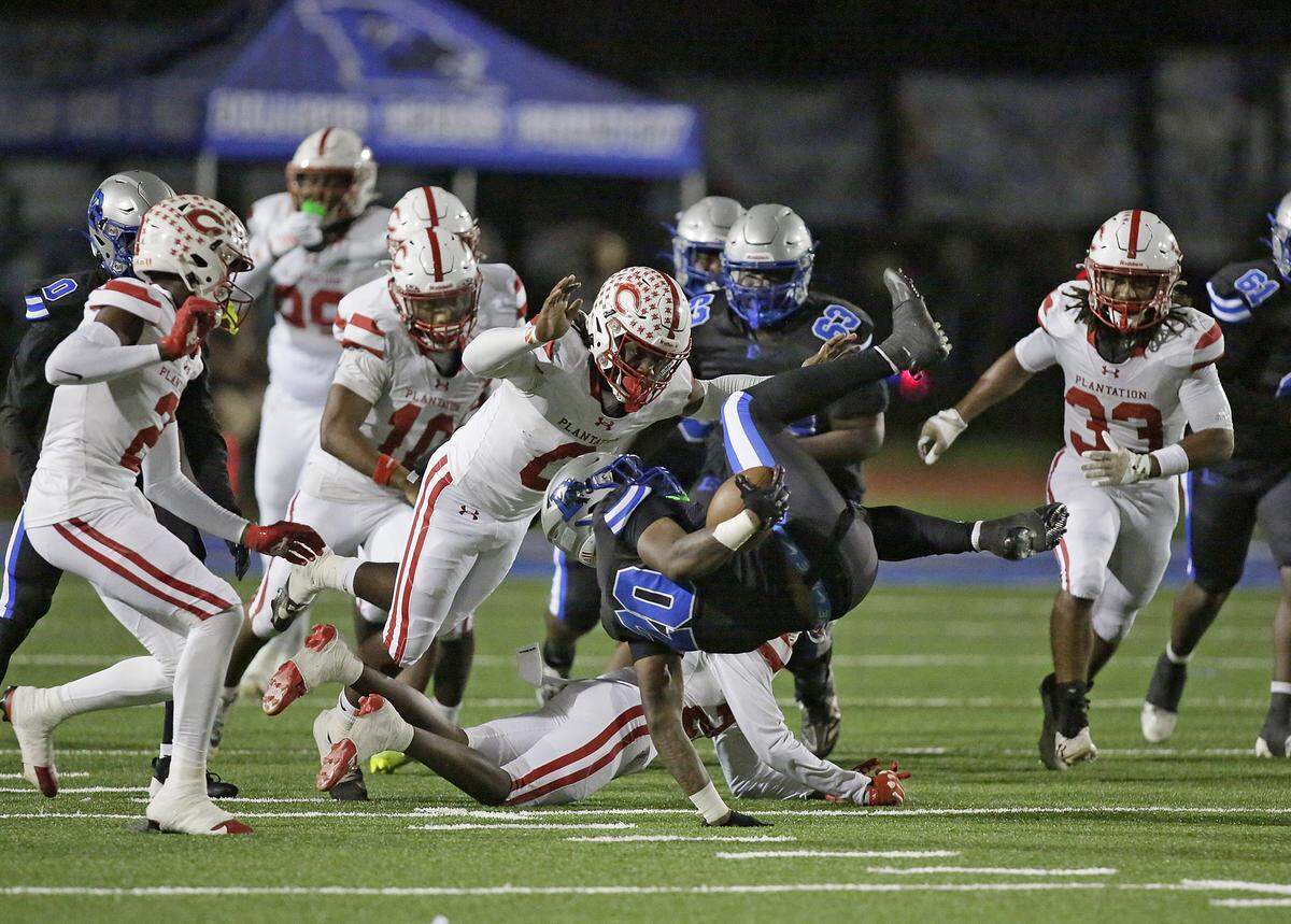 Plantation Colonels defenders take down Dillard Panthers running back Latavious Taylor (20) during Region 4-4A quarterfinal football game on Friday, November 14, 2025 at Otis Gray Jr. Memorial Stadium in Fort Lauderdale. Andrew Uloza / for Miami Herald