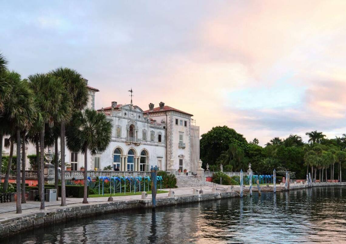 Seen from the waterfront, “Headwind” by Susanne Schirato, commissioned by the Contemporary Arts Program (CAP) at Vizcaya Museum and Gardens, 2025, draws a line of blue along the South Terrace, catching the changing light as day meets evening.