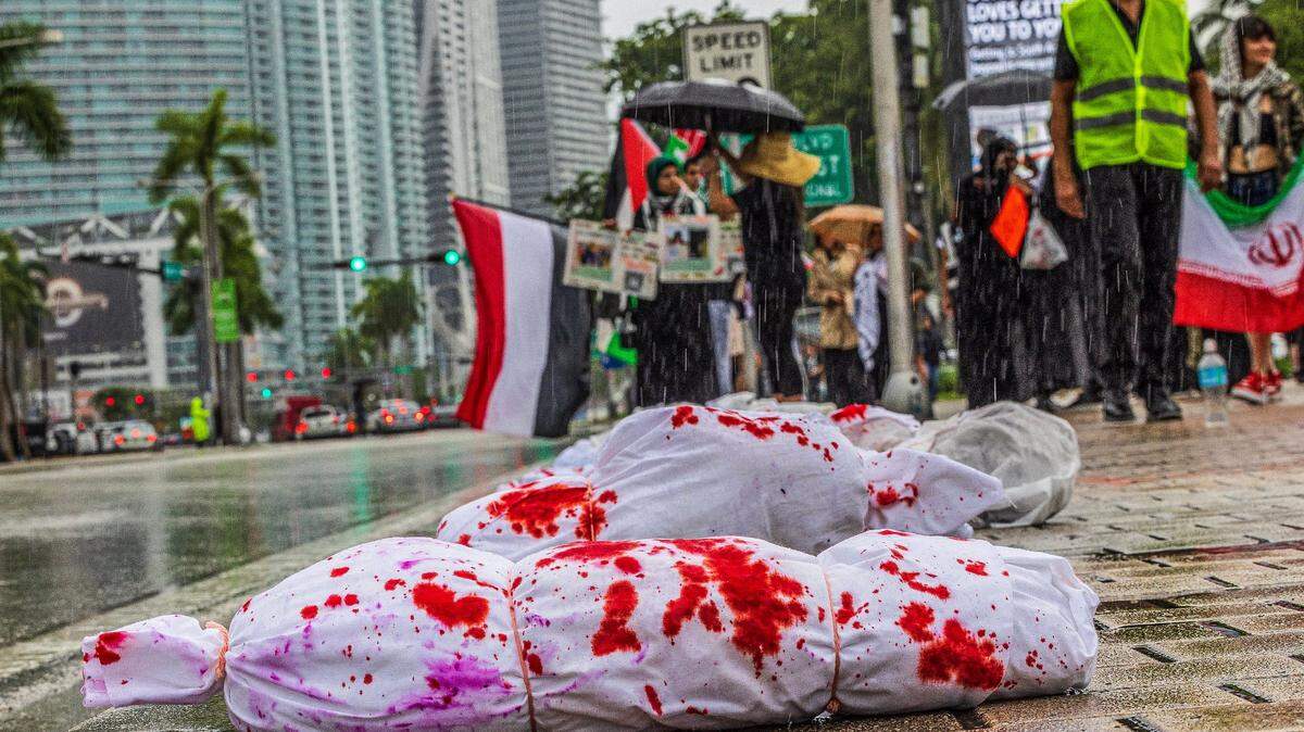 Bloody plastic bags representing dead children were laid down on the sidewalk.