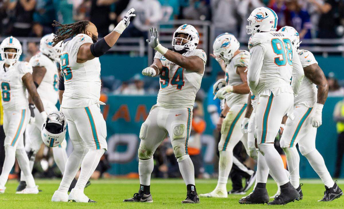 Miami Dolphins defensive tackle Christian Wilkins (94) celebrates after stripping the ball from Buffalo Bills quarterback Josh Allen (17) in the third quarter of an NFL game at Hard Rock Stadium on Sunday, Jan. 7, 2023, in Miami Gardens Fla.