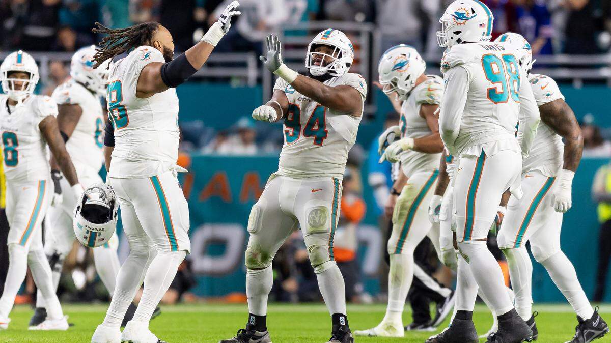Miami Dolphins defensive tackle Christian Wilkins (94) celebrates after stripping the ball from Buffalo Bills quarterback Josh Allen (17) in the third quarter of an NFL game at Hard Rock Stadium on Sunday, Jan. 7, 2023, in Miami Gardens Fla.