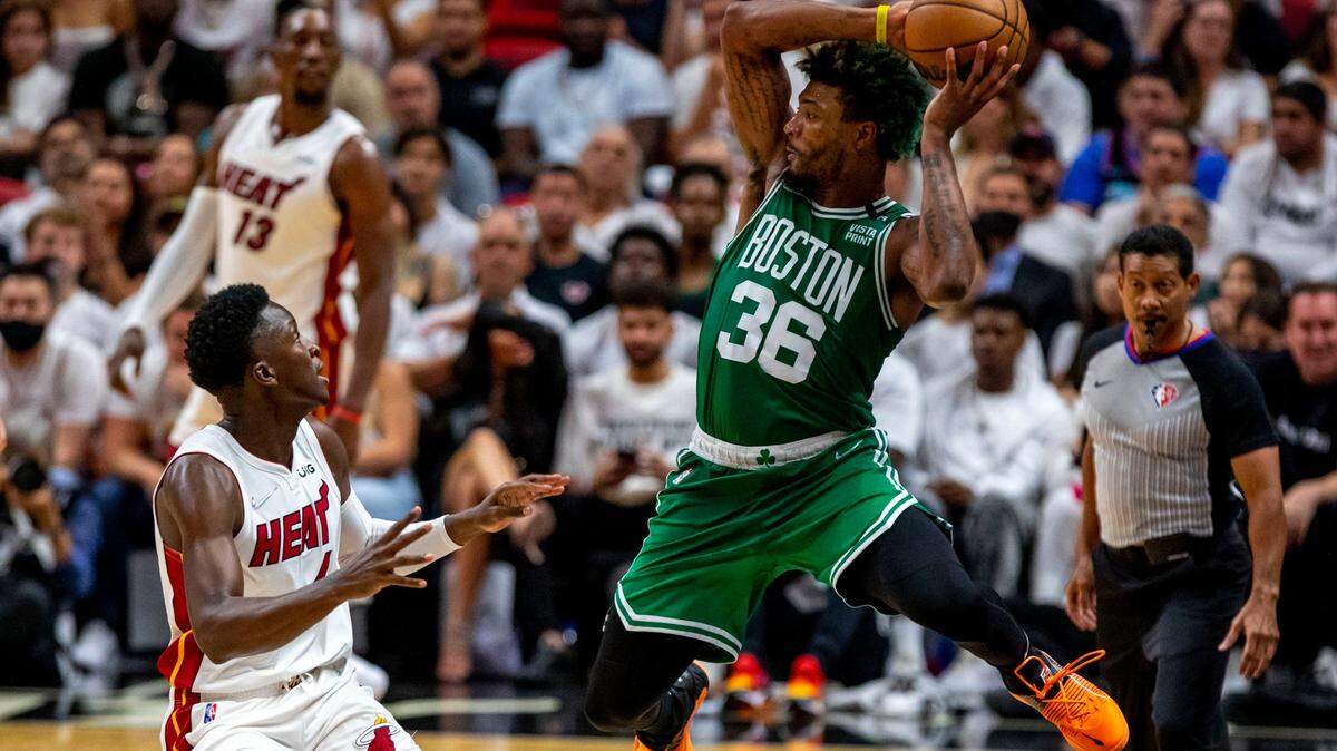 Boston Celtics guard Marcus Smart (36) attempts to save the ball from out-of-bounds while defended by Miami Heat guard Victor Oladipo (4) during the second half of Game 2 of the NBA Eastern Conference Finals series at FTX Arena in Miami, Florida, on Thursday, May 19, 2022.