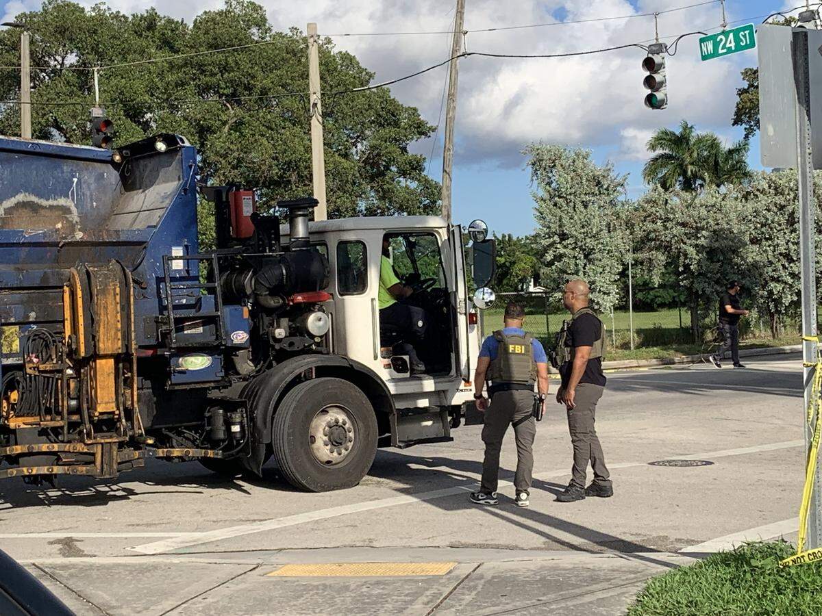 An FBI agent and another law-enforcement officer near the scene where two Miami police officers were shot Thursday morning, Oct. 9, 2025, around Northwest 24th Street and 17th Avenue, police said.