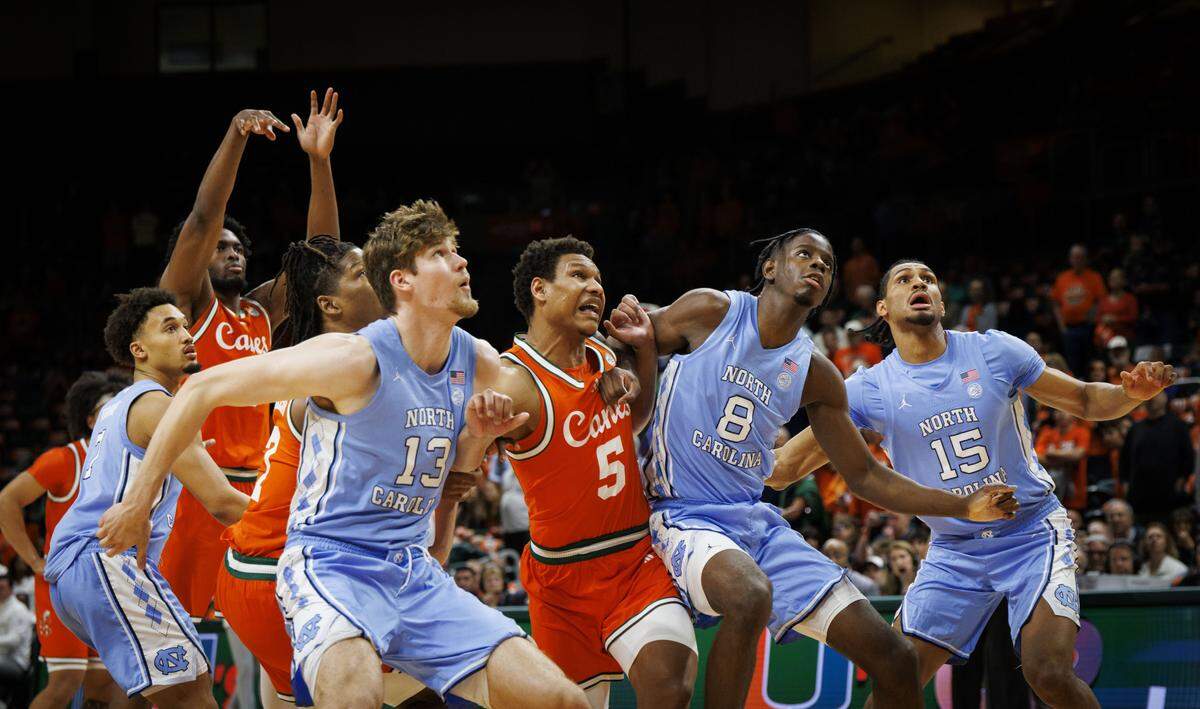 Miami Hurricanes forward Malik Reneau (5) tries to get through North Carolina Tar Heels center Henri Veesaar (13) and forward Caleb Wilson (8) during the first half of a game on Tuesday, Feb. 10, 2026, at the Watsco Center in Coral Gables, Fla. 
