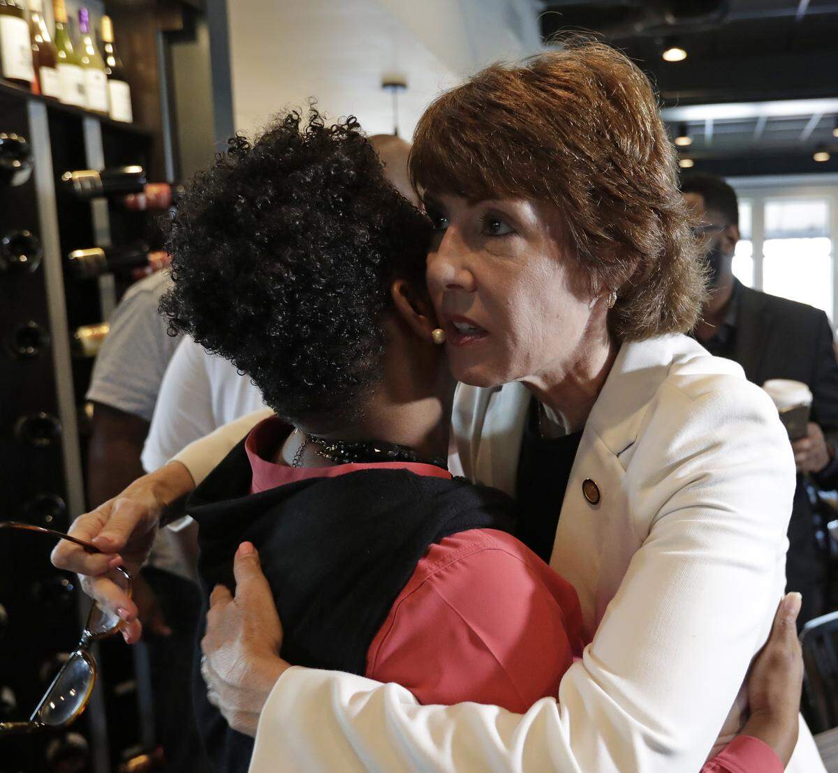Florida Democratic gubernatorial candidate Gwen Graham, right, hugs Florida Rep. Tracie Davis before meeting community leaders about gun violence Monday, Aug. 27, 2018, at a restaurant near the scene of a Sunday mass shooting at The Jacksonville Landing.