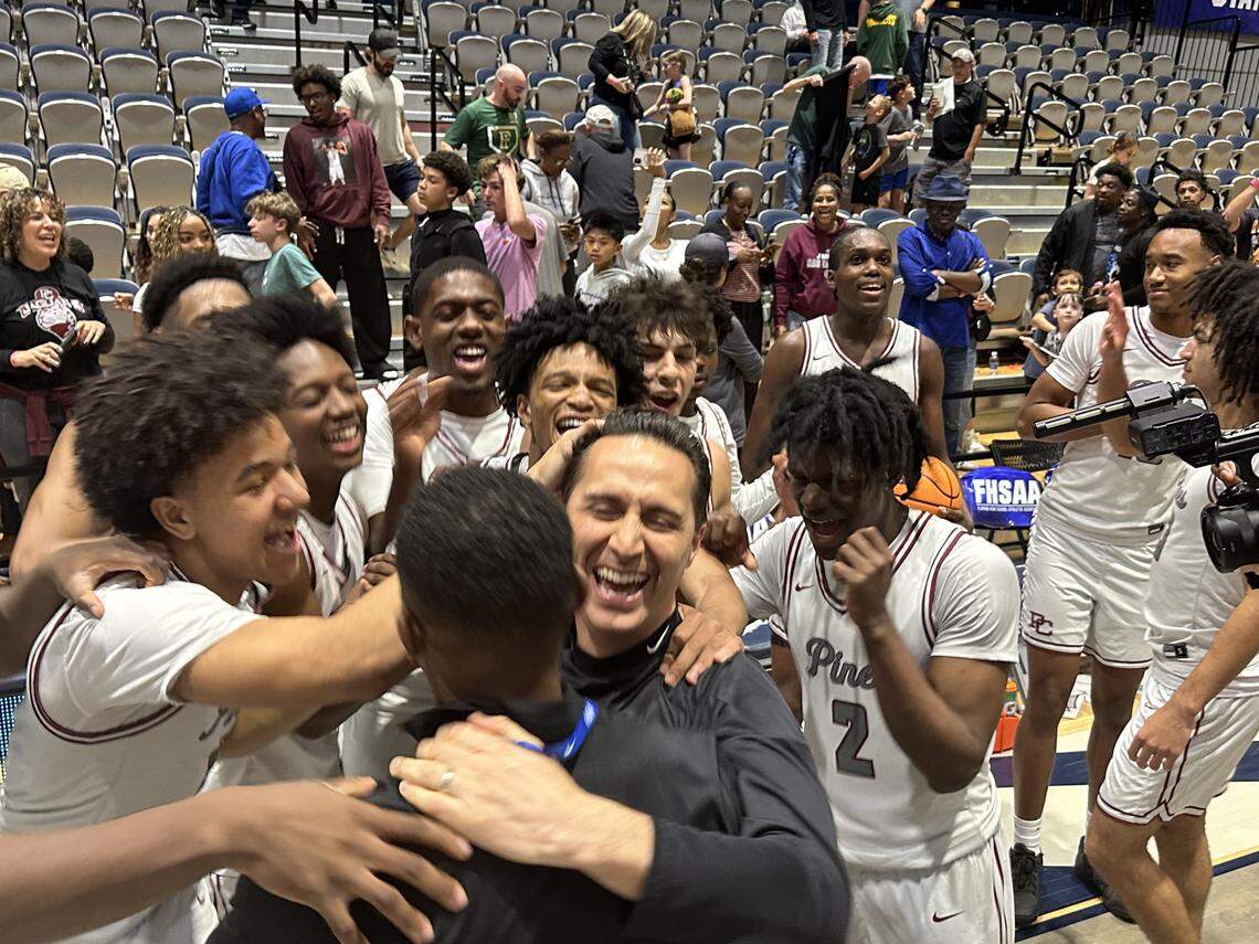 Pembroke Pines Charter coach Dave Roca and his players are all smiles as they celebrate their Class 5A state championship victory over Fleming Island on Friday at UNF Arena in Jacksonville, Fla.