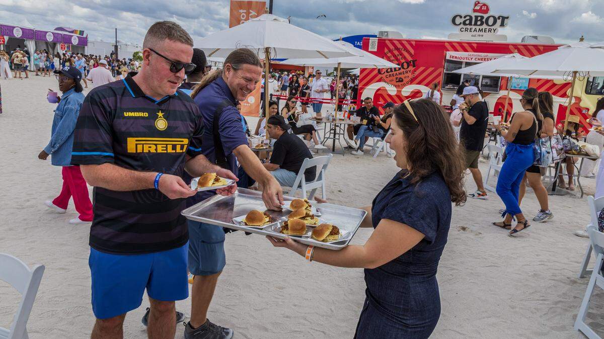 Influencer Alessandra Ciuffo-@flavorsbyalssandra serves bites of “Sloppy Giuseppe’s” during the Grand Tasting Village, SoBe Wine & Food Festival, in Miami Beach, on Saturday, February 22, 2025. 